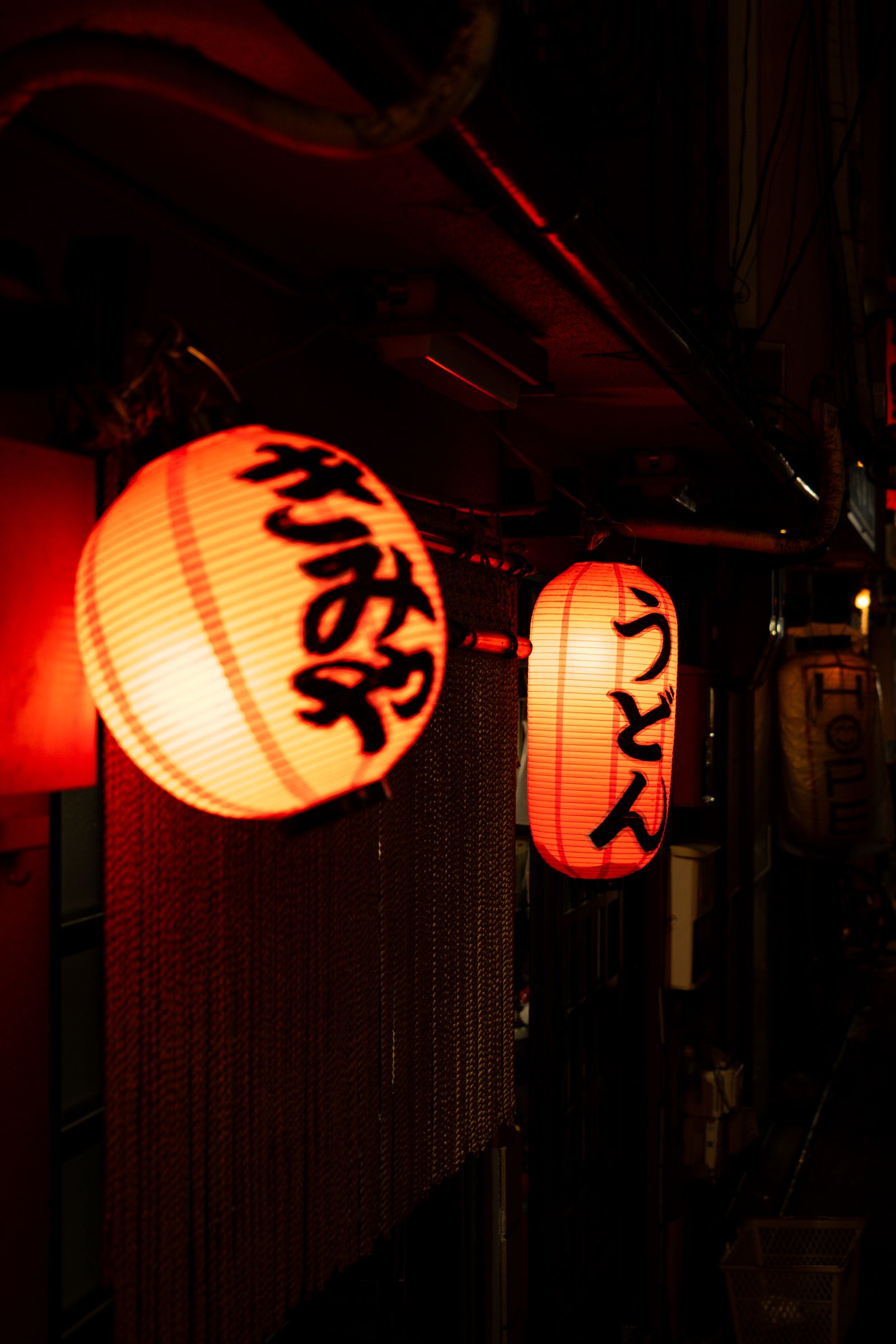 Lanterns glowing in a Kyoto alley at night