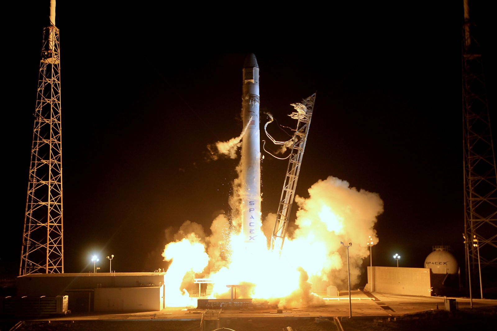 Long-exposure arc of a rocket launch at night
